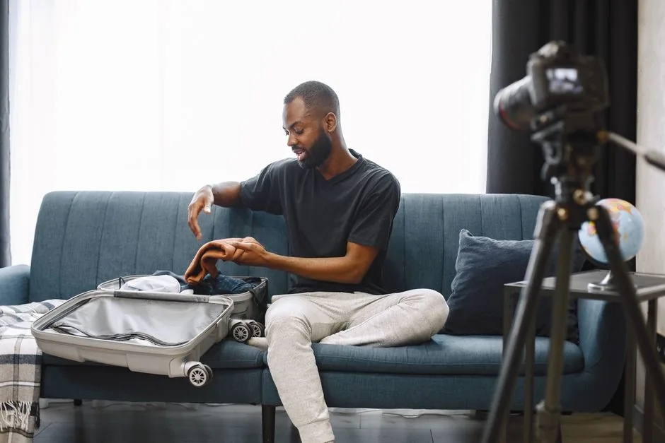 traveler packing a small suitcase with packing cubes